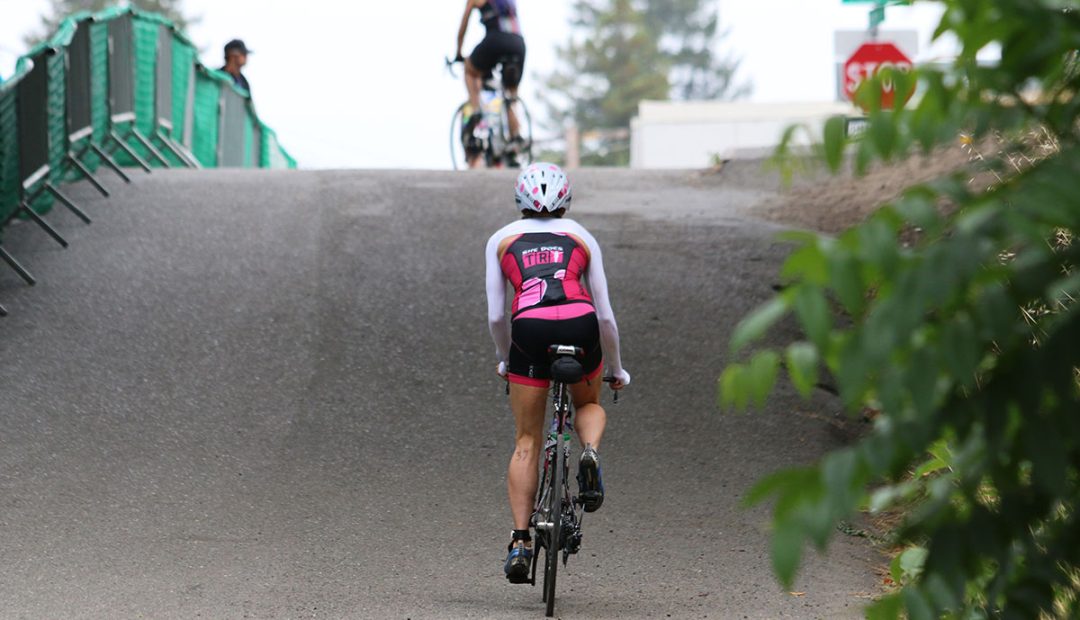 krista climbing on bike vineman