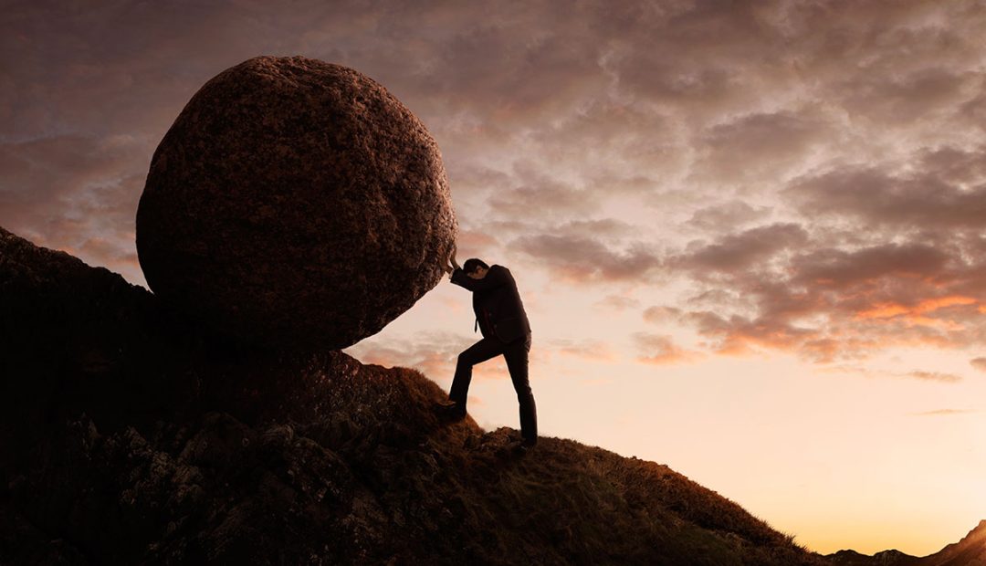 pushing boulder up a mountain