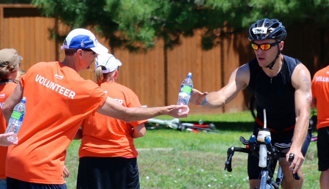 triathlete at aid station